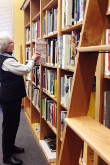 Woman selecting book at Morse library