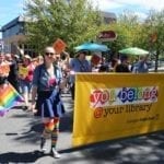 people marching with library banner in Pride Parade