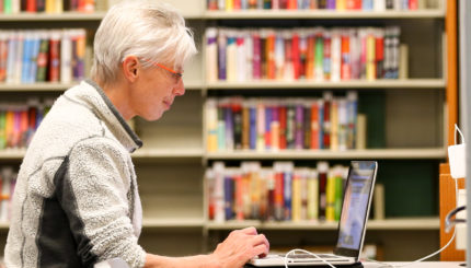 woman using laptop at library