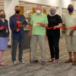 Library Leaders hold ribbon to be cut