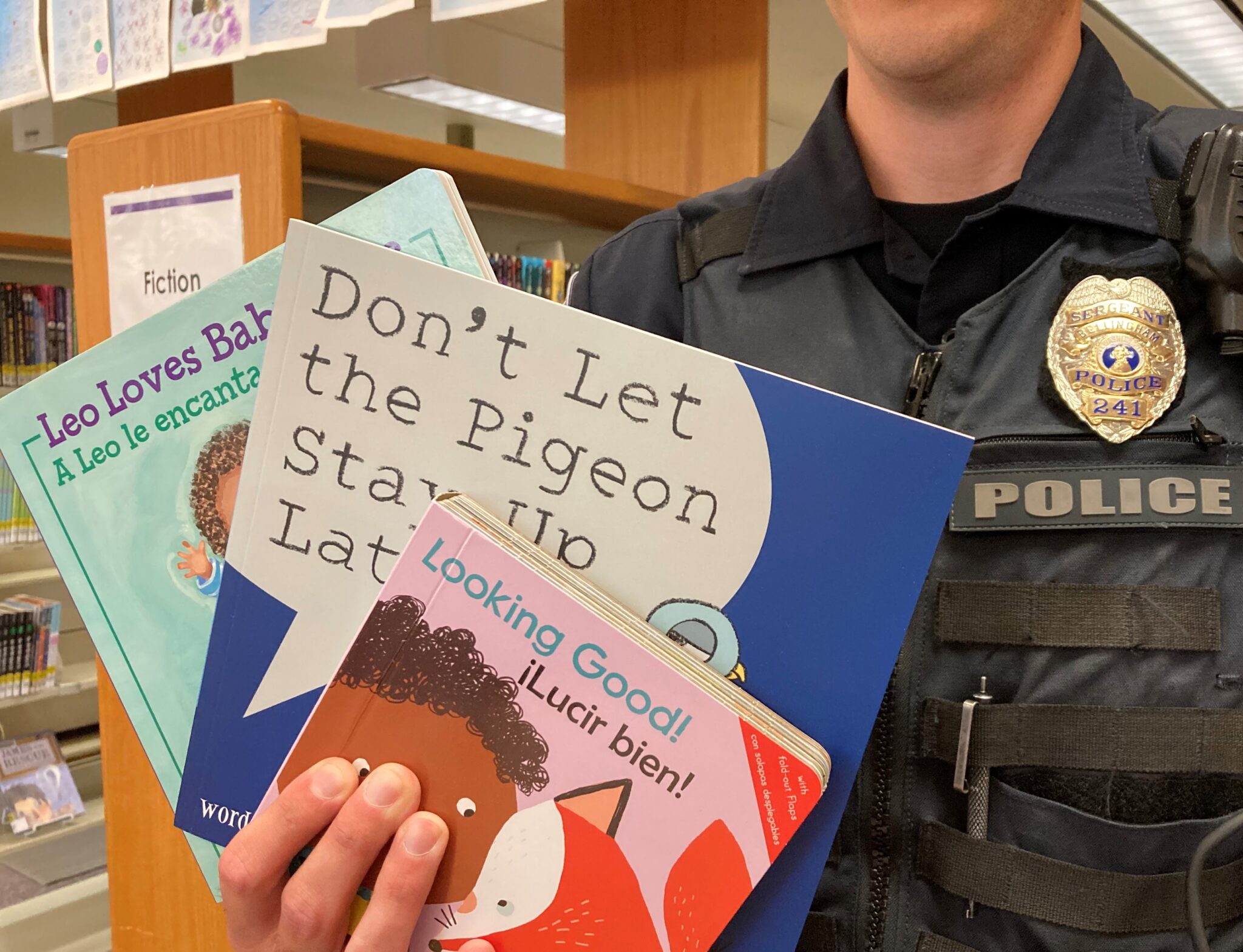 police officer holding children's books
